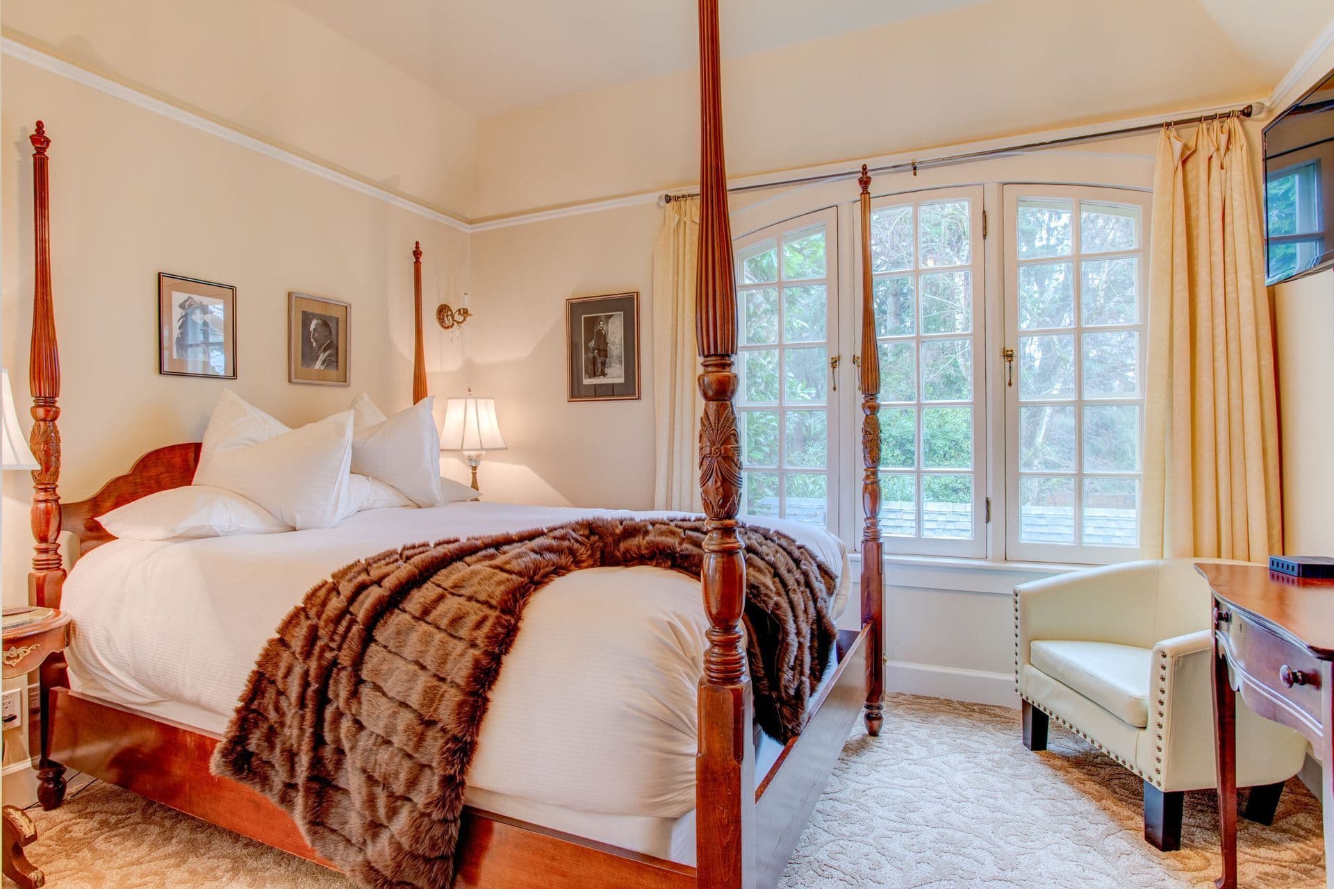 Four-poster bed and a chair in the Ulysses & Julia Room